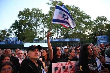 Person holds Israeli flag at Oct. 7 anniversary ceremony in Central Park