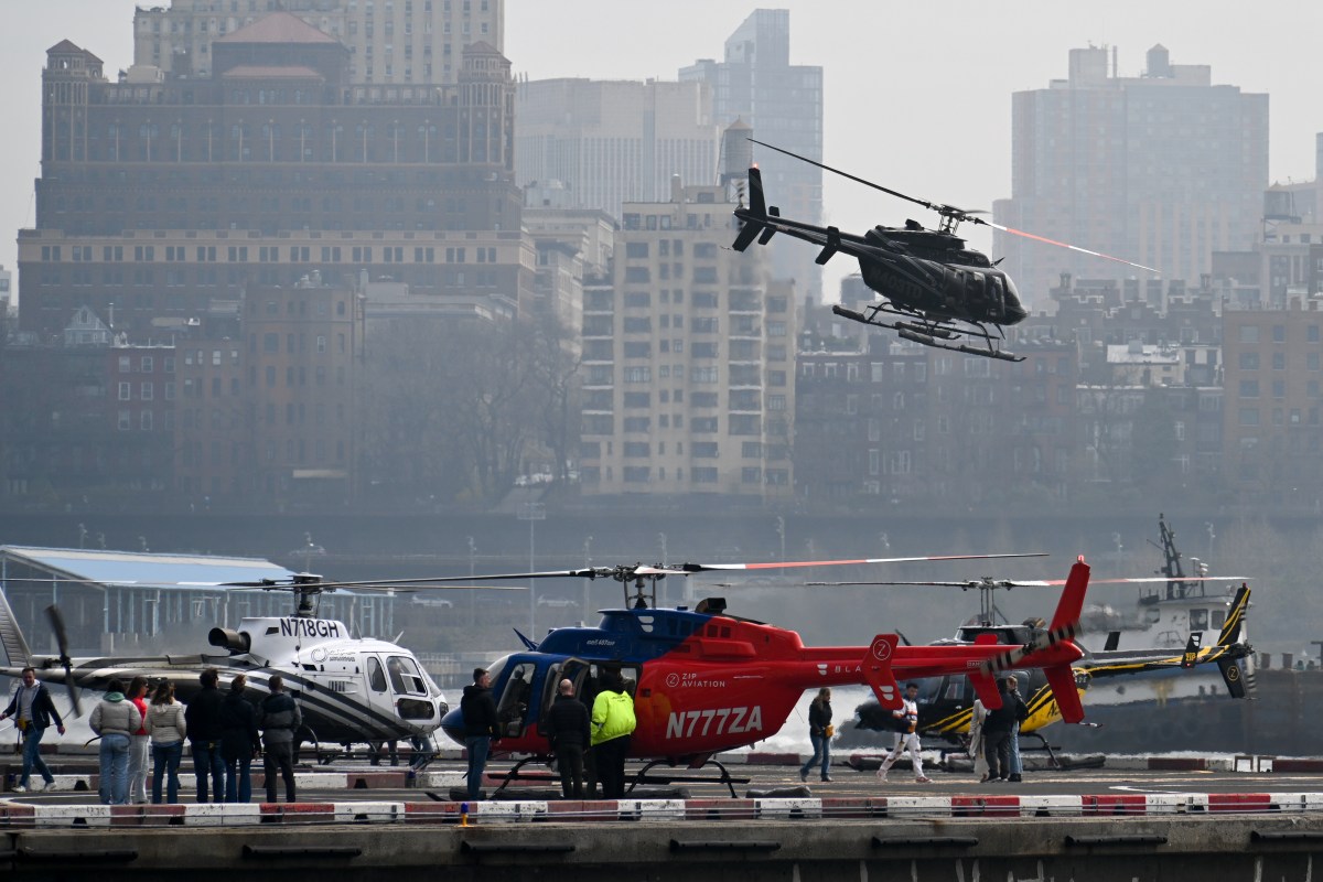 Downtown Manhattan Heliport to modernize with electric technology under new operator 2 Helicopters landing and waiting at Downtown Manhattan Heliport