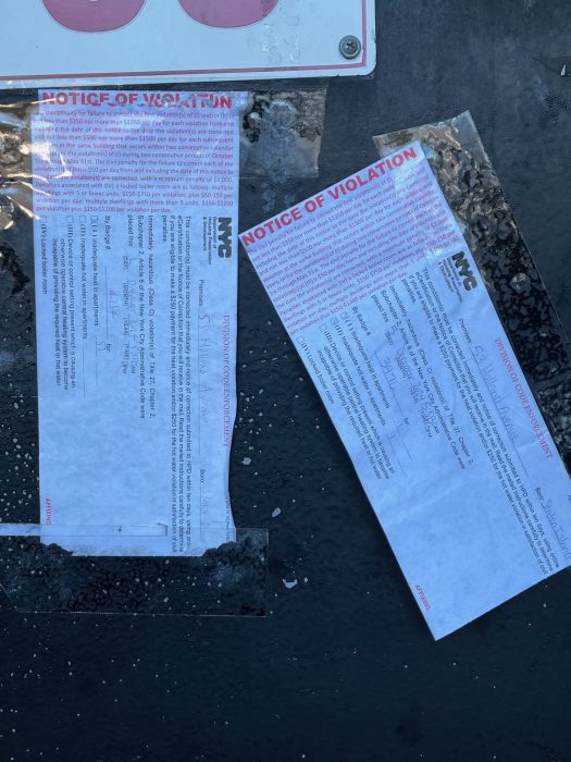 violation notices on the door of a housing complex in Staten Island 