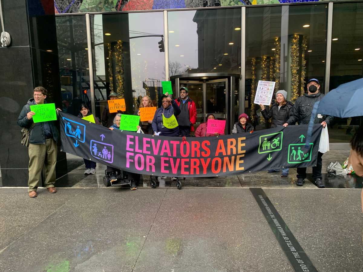 New Yorkers protest outside MTA headquarters in Lower Manhattan advocating for better subway accessibility.