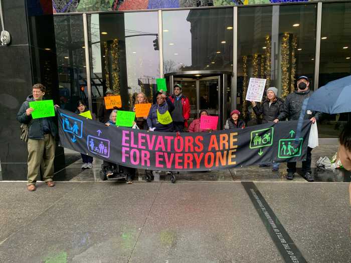 New Yorkers protest outside MTA headquarters in Lower Manhattan advocating for better subway accessibility.