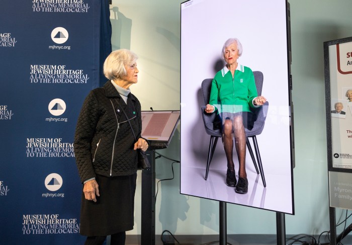 Levy poses next to her video on the newly launched 'Survivor Stories: An Interactive Dialog'.