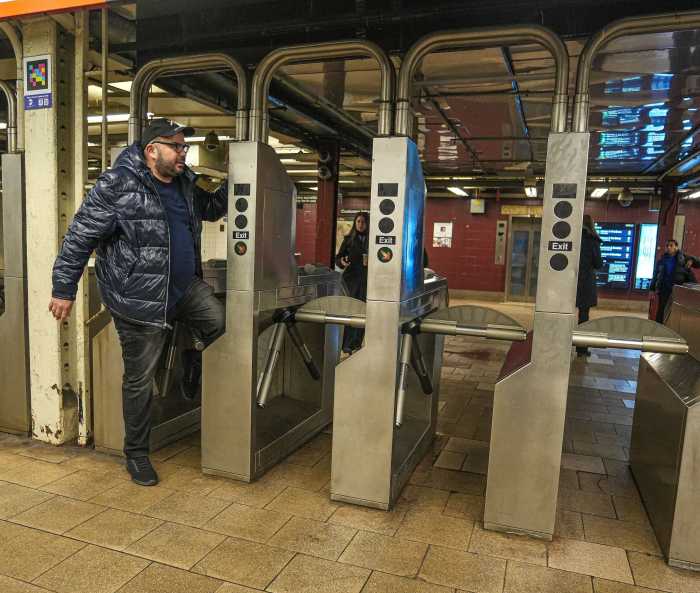 War on fare evasion continues as MTA set to install delayed emergency exit doors at 150 additional subway stations 2 a man doing fare evasion through a turnstile