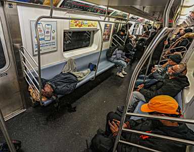 Straphangers say they commute in rush hour alongside sleeping homeless.