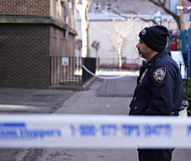 A police officer at a crime scene in Harlem.