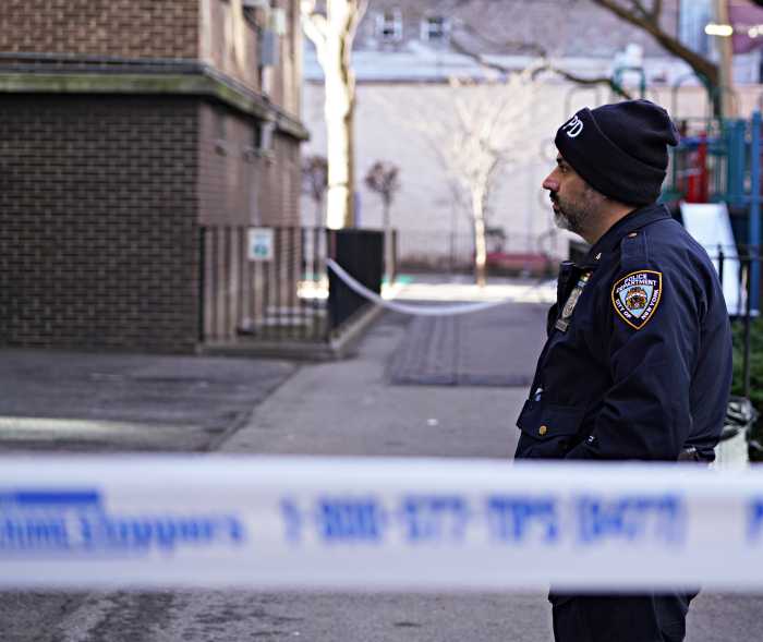 A police officer at a crime scene in Harlem.