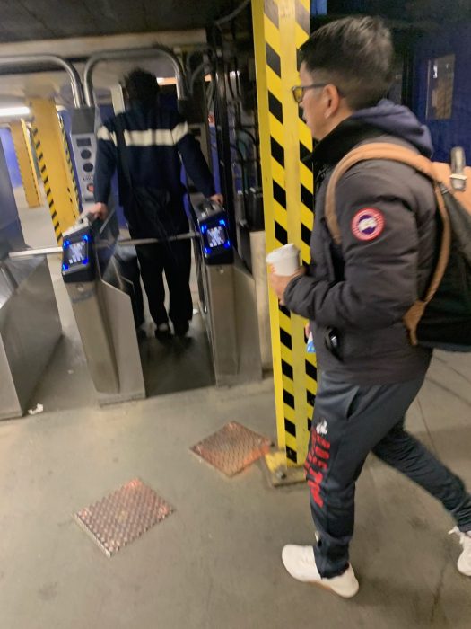 person jumping turnstile in Queens subway station