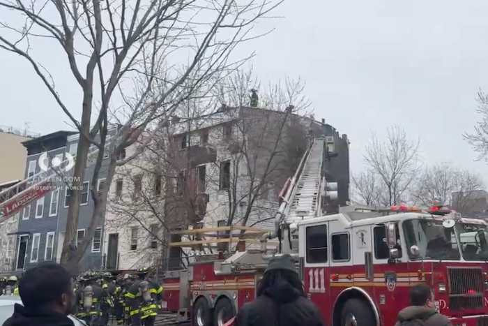 Firefighters at scene of Brooklyn fire where firefighter suffered cardiac arrest