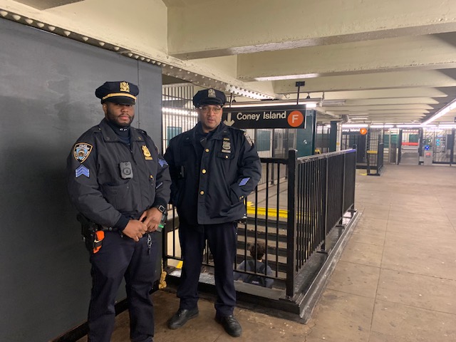 two police officers in a subway station