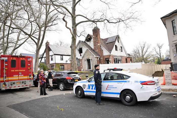 Easter tragedy: Fatal two-alarm fire rips through Queens home, killing three people 2 police car in front of a house that was demolished by fire