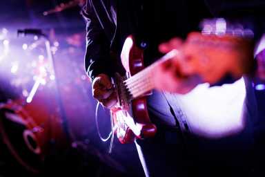 Close up of a musician playing the electric guitar during a concert