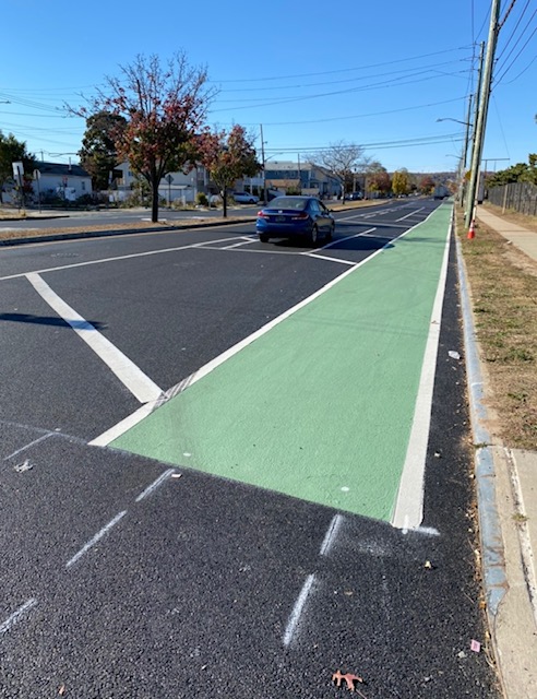 a street on State Island with one car parked on it