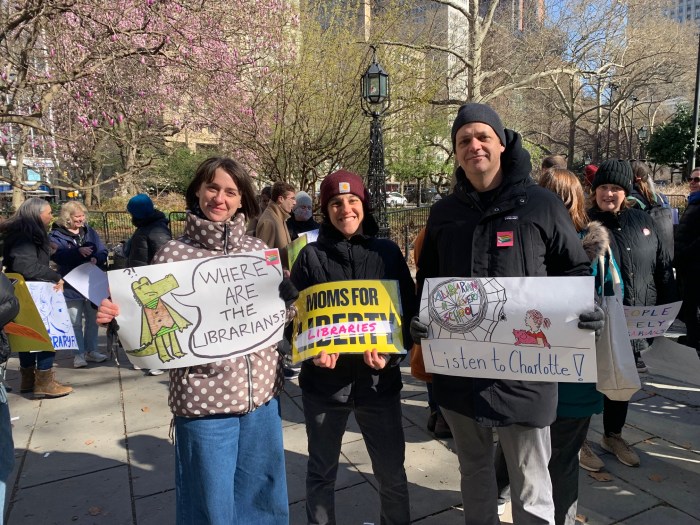 Reopen the books: Parents, teachers and students rally to restore NYC public school libraries 2 three people outside holding signs advocating for public school libraries in NYC