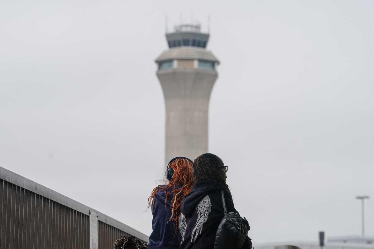 Radar blackouts at Newark Airport continue to spark safety fears and political pressure to fix systems 2 People near control tower at Newark Liberty Airport