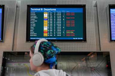 Passenger with screen of delayed flights at Newark Airport