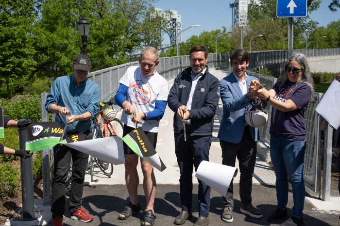 MTA opens a 'biker's paradise' on RFK-Triborough Bridge 3 people cutting a ribbon on a bike path
