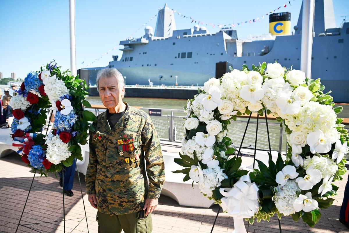 Memorial Day 2025: Intrepid Museum's service pays homage to generations of American freedom-fighters 2 Man in military uniform near memorial wreaths on Memorial Day