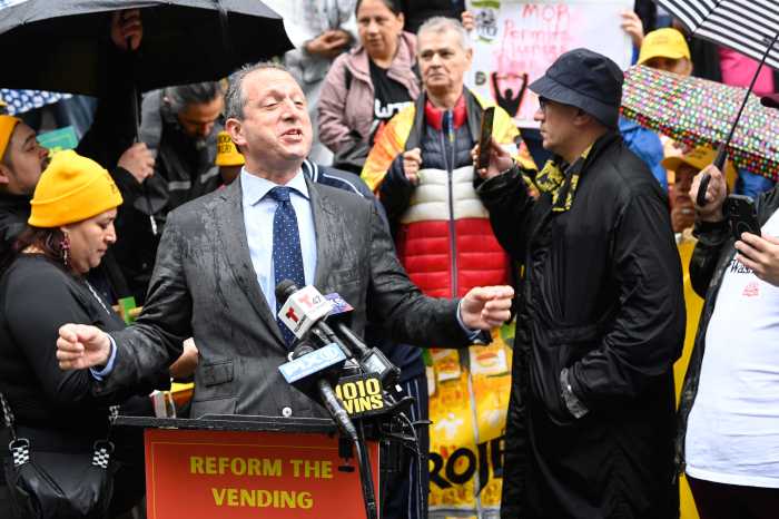 man at a podium during a street vendors rally