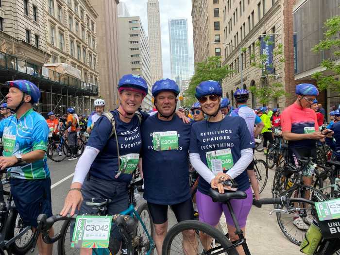 What rain? Thousands turn out for TD Five Boro Bike Tour through NYC on Sunday despite dreary skies 4 three people with bikes in a NYC street