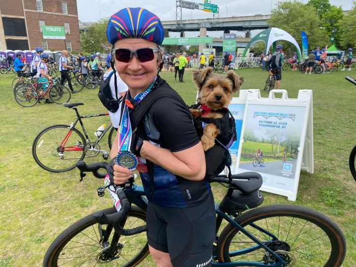 woman an small dog on a bike