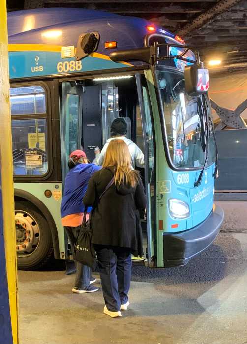 people boarding a NYC bus