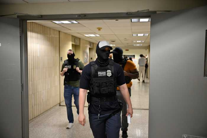 Masked federal agents roaming 26 Federal Plaza during immigration court hearings on June 21, 2025.