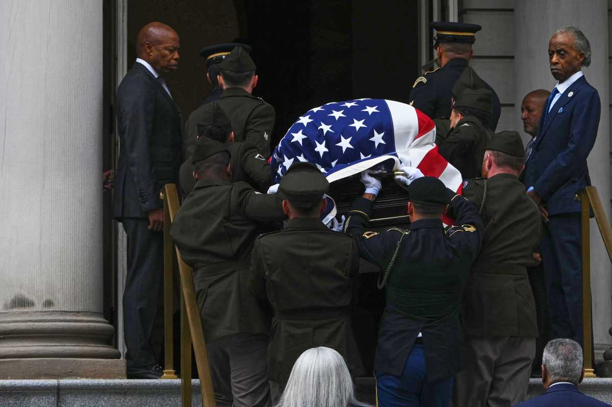 Mayor Eric Adams watches as members of the 369th Regiment escort the casket carrying US Rep. Charles Rangel into City Hall on June 11, 2025.