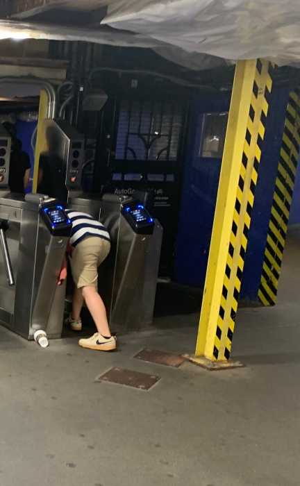 Subway shame! Fare evasion thrives despite MTA and NYPD efforts to stop the revenue-losing scourge 2 person ducking under a turnstile in a subway station