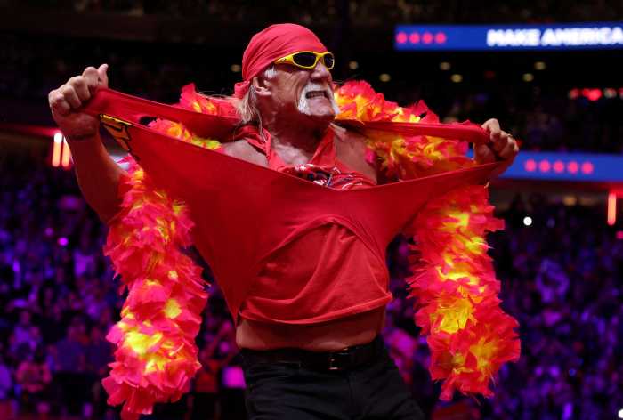 man in red shirt, boa and sunglasses Hulk Hogan tears off shirt
