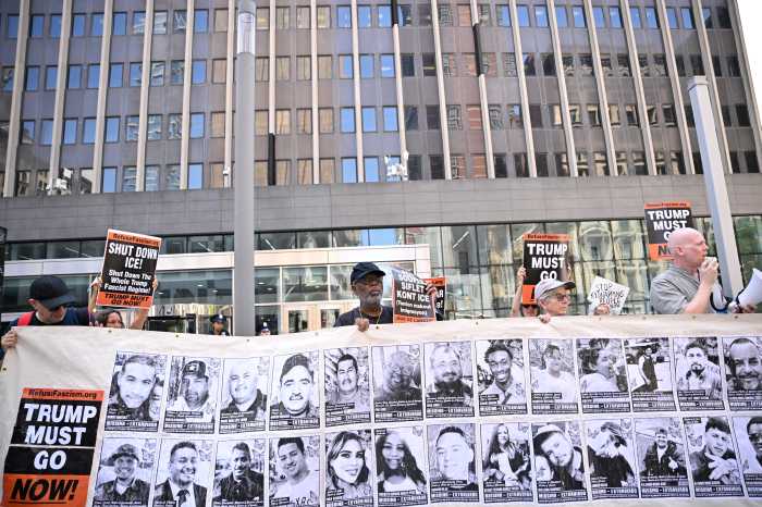 ICE in courts: Feds cuff more immigrants as protesters decry detentions outside 26 Federal Plaza 3 Protesters hold a banner displaying images of detained immigrants outside 26 Federal Plaza during a rally against ICE detentions.
