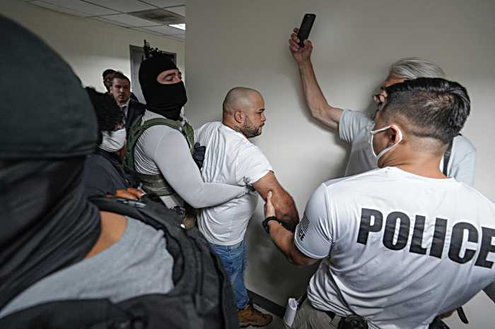 An migrant is grabbed by ICE.