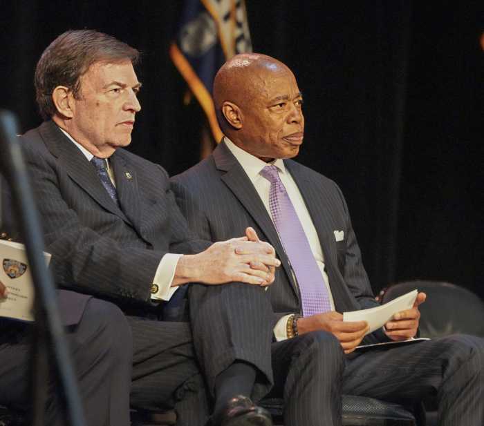 two men sitting and looking intently at something