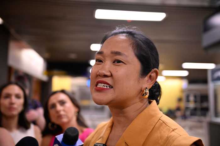 Melissa Chua, director of the Immigration Protection Unit at NYLAG, speaks to reporters indie the Port Authority Bus Terminal on July 18, shortly before the arrival of Derlis.