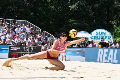 a woman playing beach volleyball