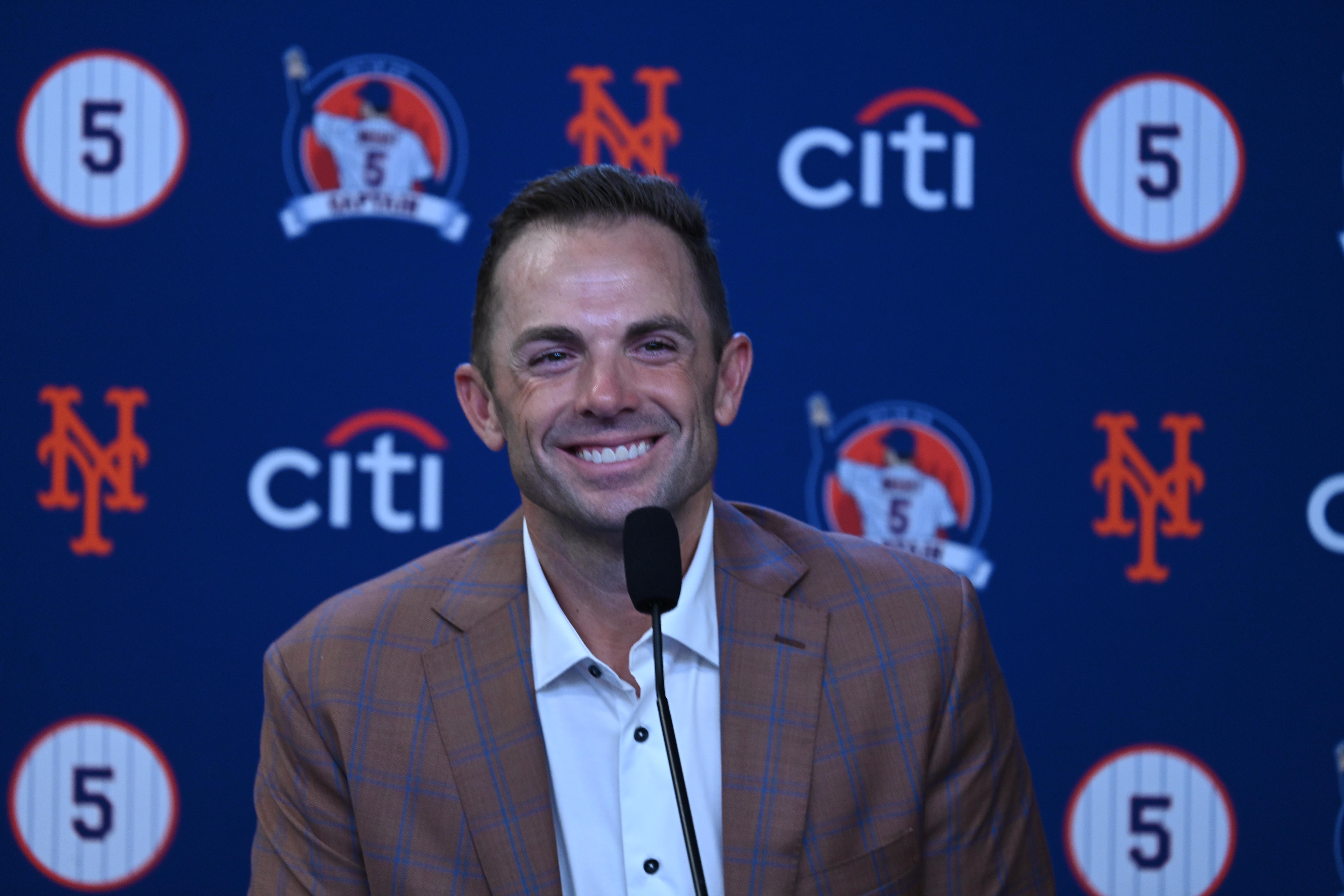 David Wright: Man stands in front of blue backdrop smiling.