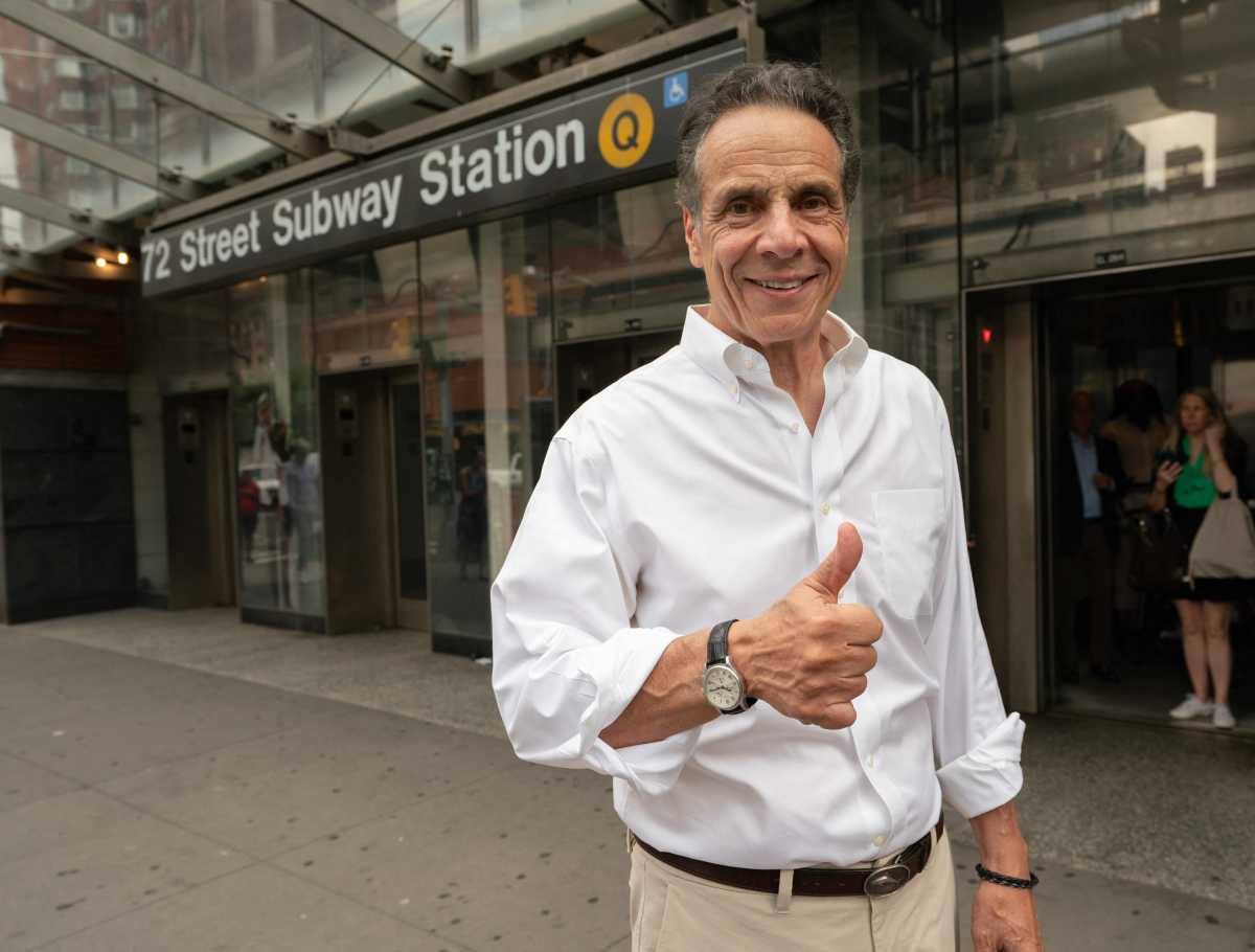 man wearing shirt holding thumbs up near subway station in campaign