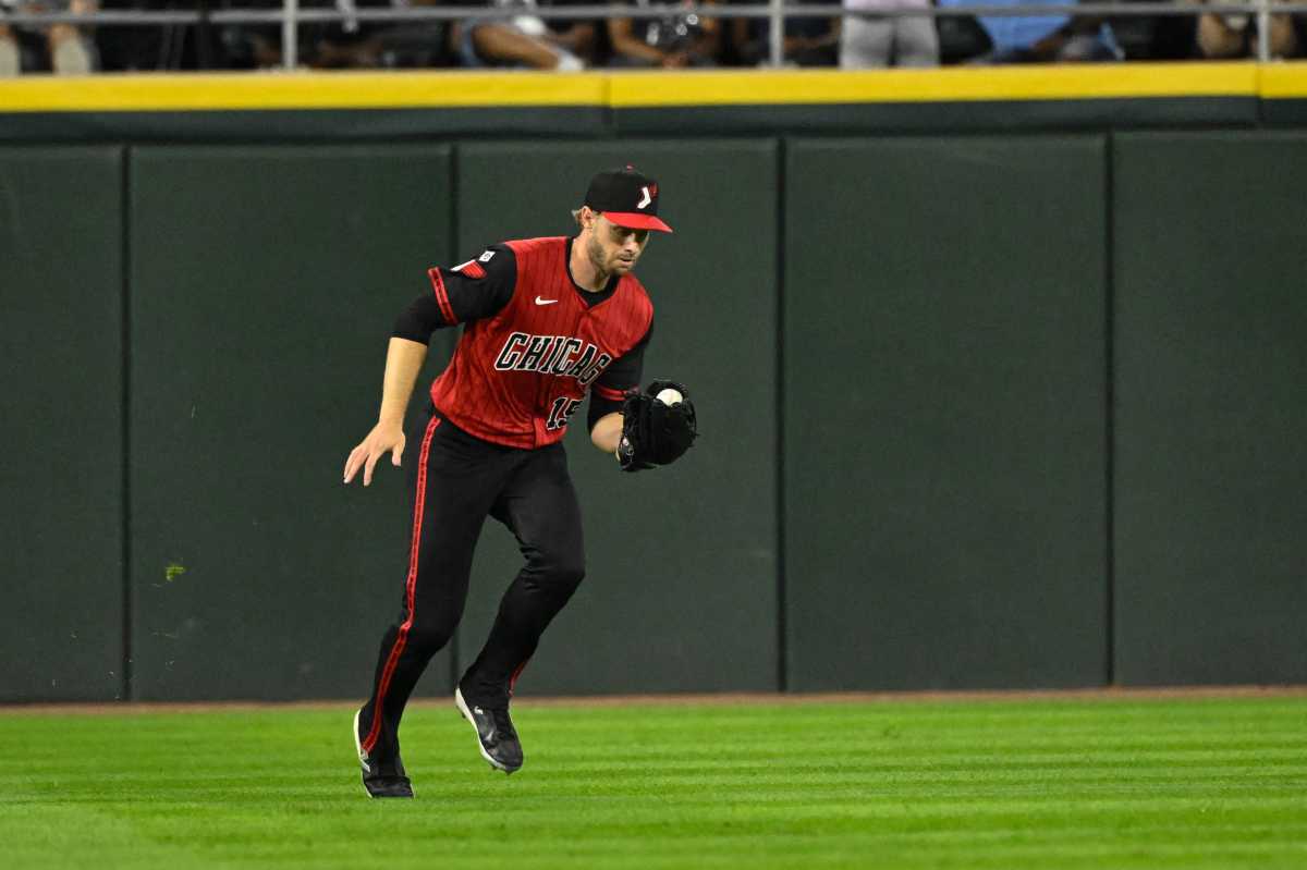 Austin Slater Yankees: Man in red and black uniform catches baseball