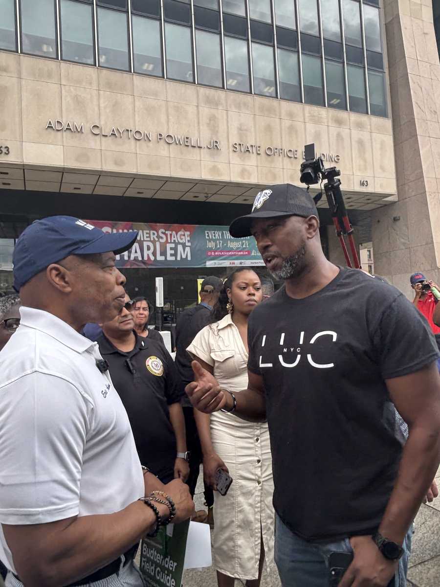 two men talking to each other in front of building about cannabis policies
