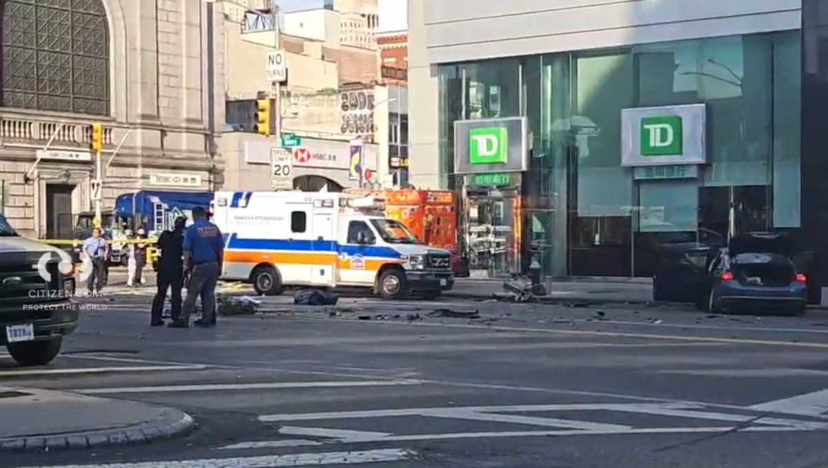Chinatown hit-and-run crash: Driver accused of fatally mowing down two people had guns in car, prosecutors say 2 police officers and ambulance at scene of hit-and-run crash in Chinatown with debris on ground