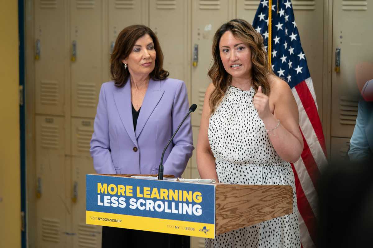Cellphone ban will start at NYC Public Schools in September; here's what to know 2 two women speaking at podium about cellphone ban in public schools
