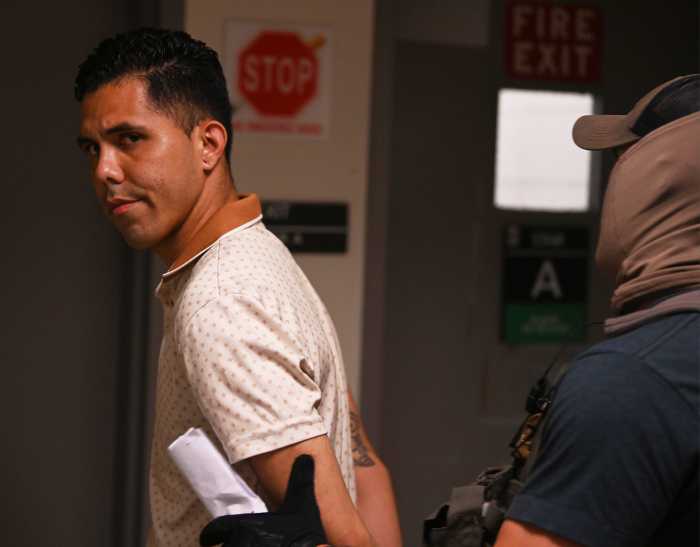 ICE in courts: More immigrants cuffed at Federal Plaza as even officers feel the strain 5 a man in a white shirt getting arrested