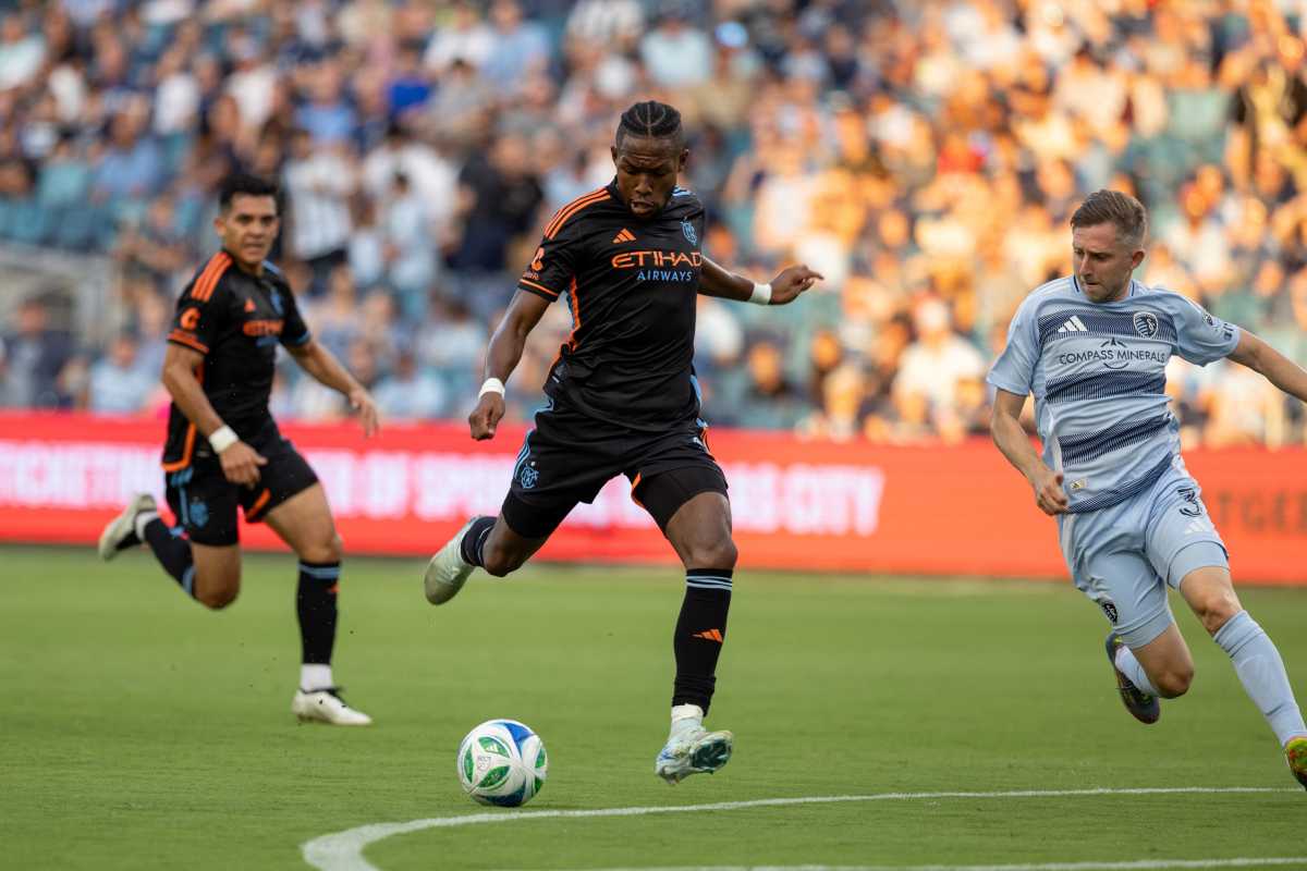 Player in black clothing kicks soccer ball on field for NYCFC