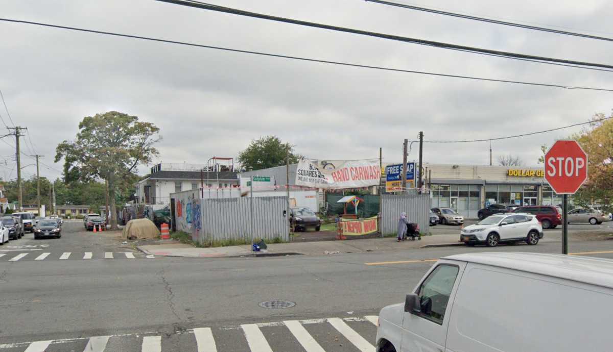 Intersection with van, buildings and stop sign in Queens