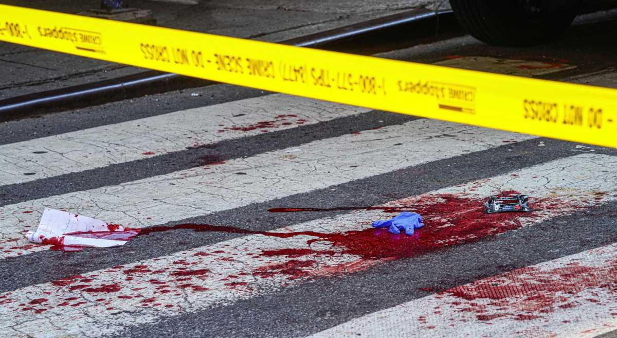 blood on pavement with police line