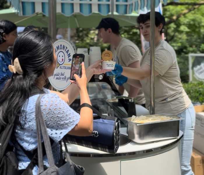 People serving ice cream and gelato to customer at park