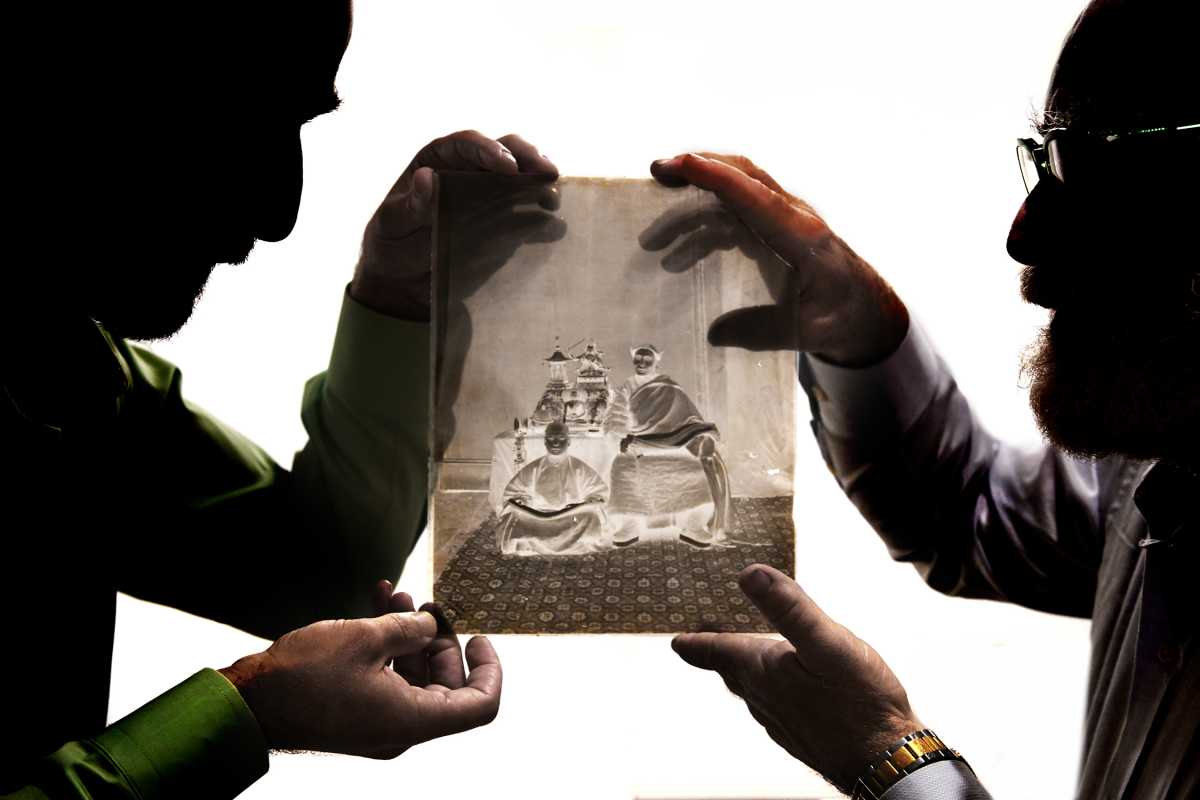 two men in Flatiron District holding up glass negative photography