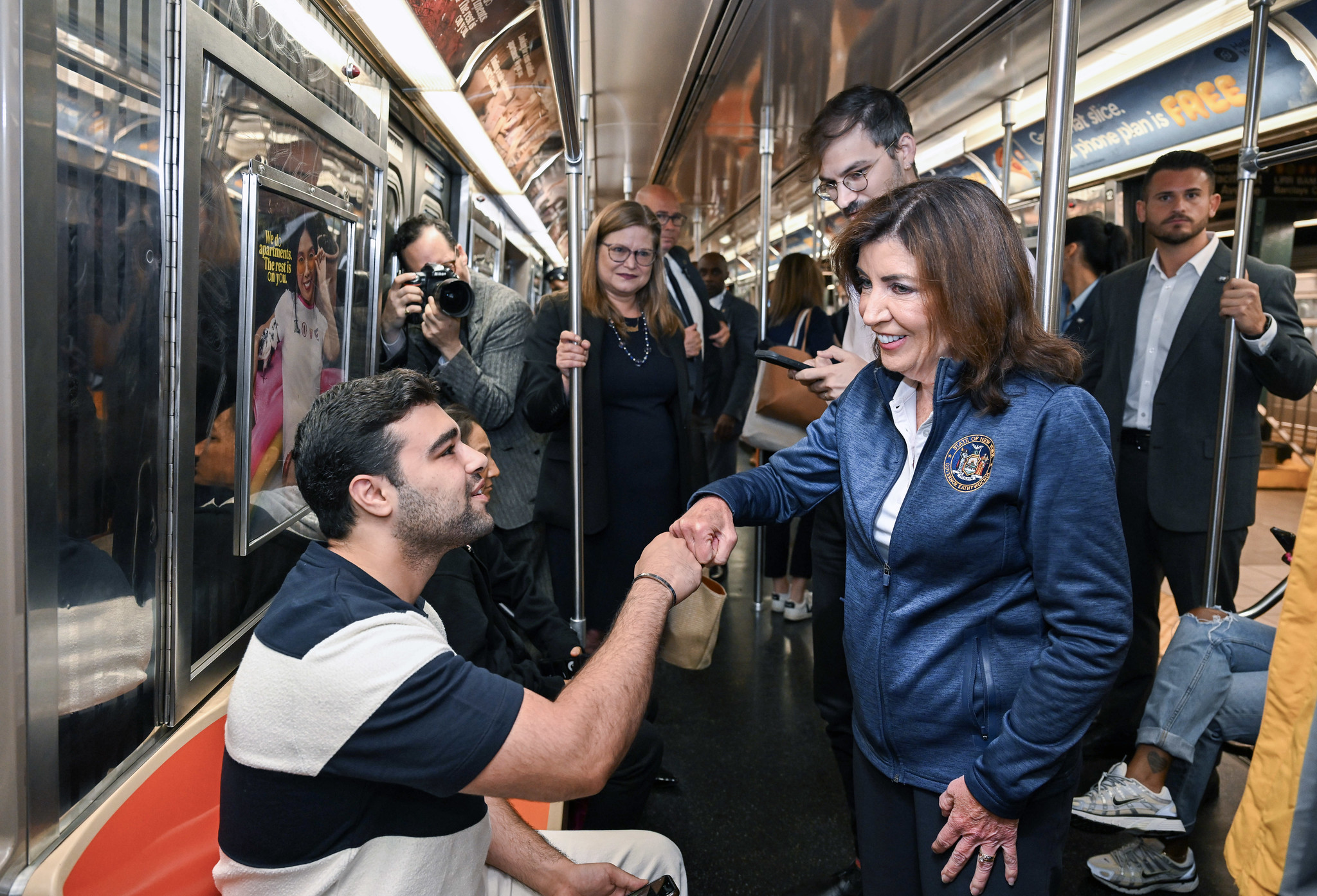 Woman shakes man's hand on subway. Governor Kathy Hochul came to Brooklyn Friday morning for a victory lap after the MTA board's design contract approval for the Brooklyn-Queens Interborough Express, or IBX.