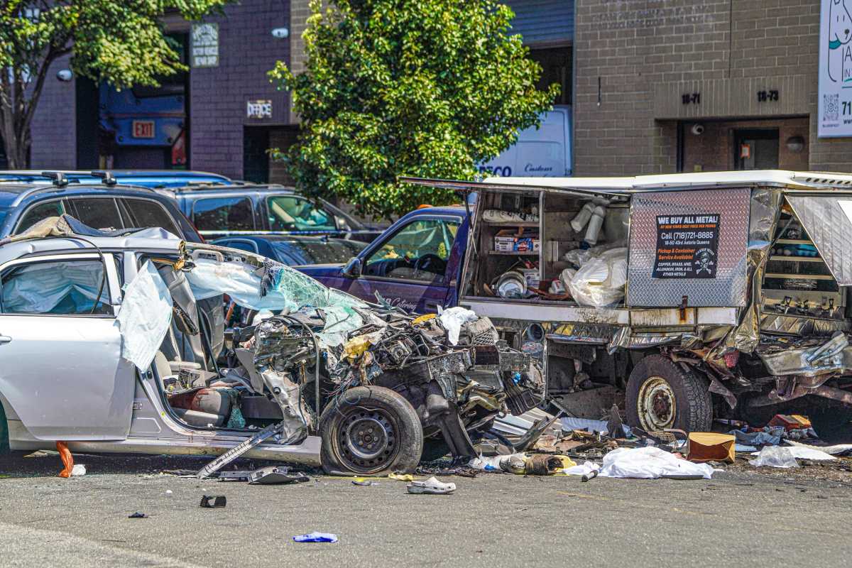 crushed vehicle and food cart after crash in Queens
