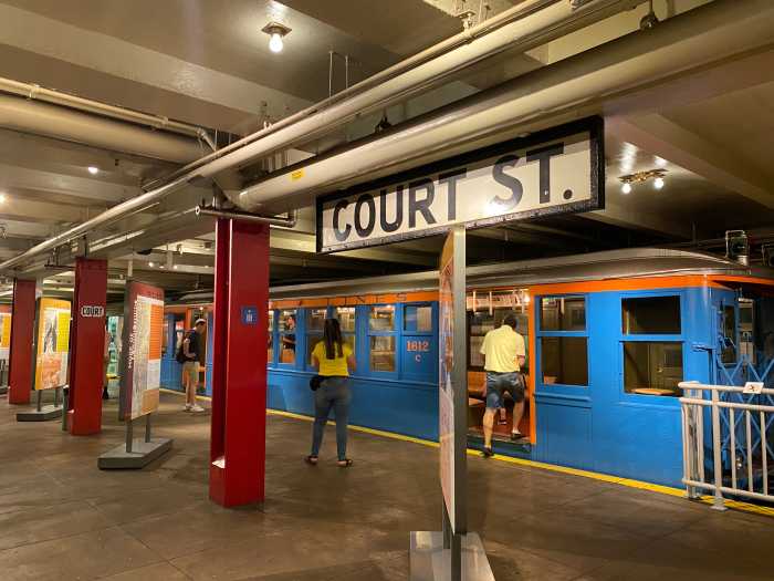 Inside the Transit Museum’s Court Street station: vintage trains rest on tracks still powered by a live third rail.