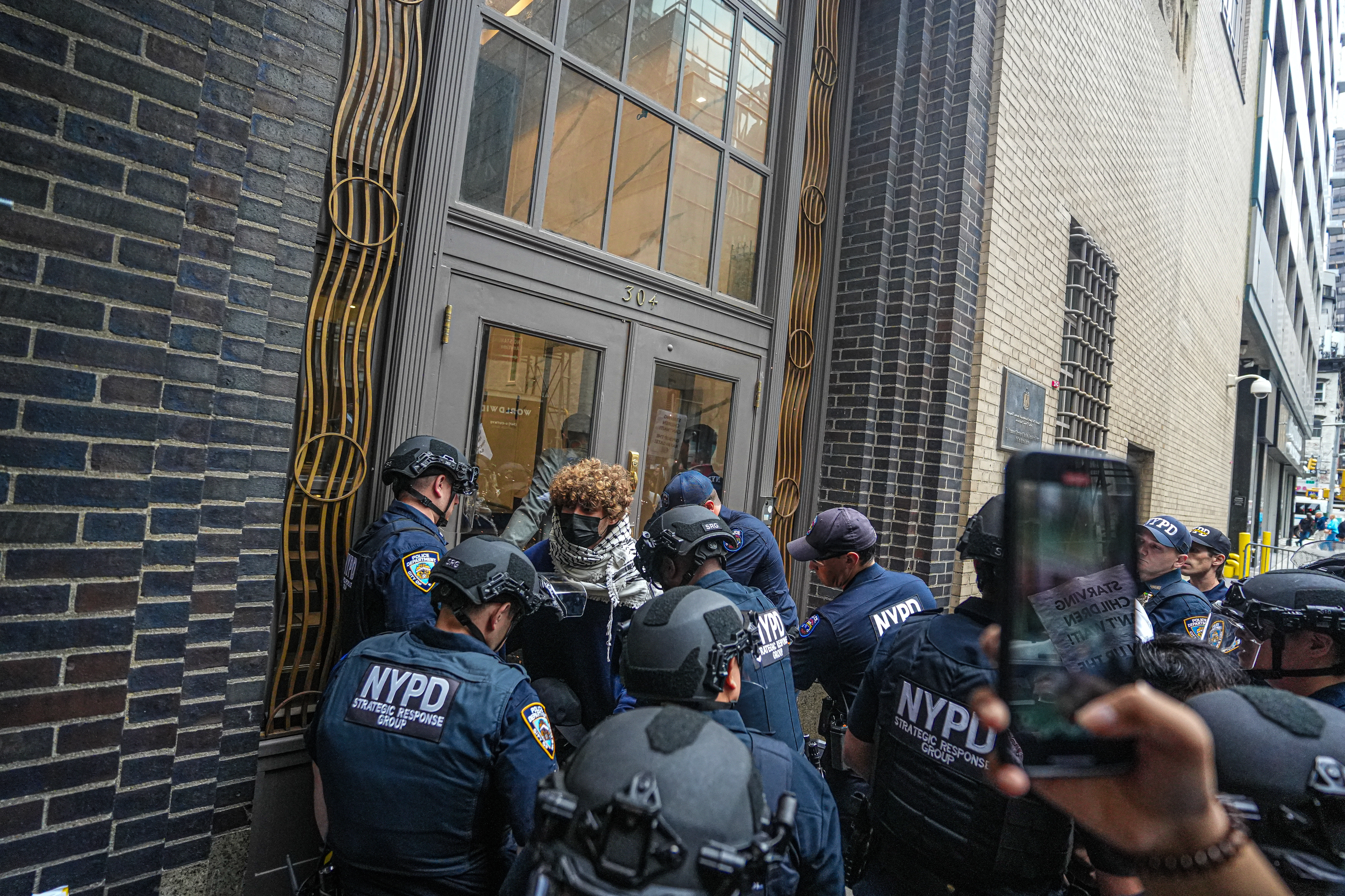 Five pro-Palestine protesters in custody after chaining themselves to UN's Permanent Mission of Egypt building in Midtown 5 NYPD in the SRG unit arrest protesters in Midtown.